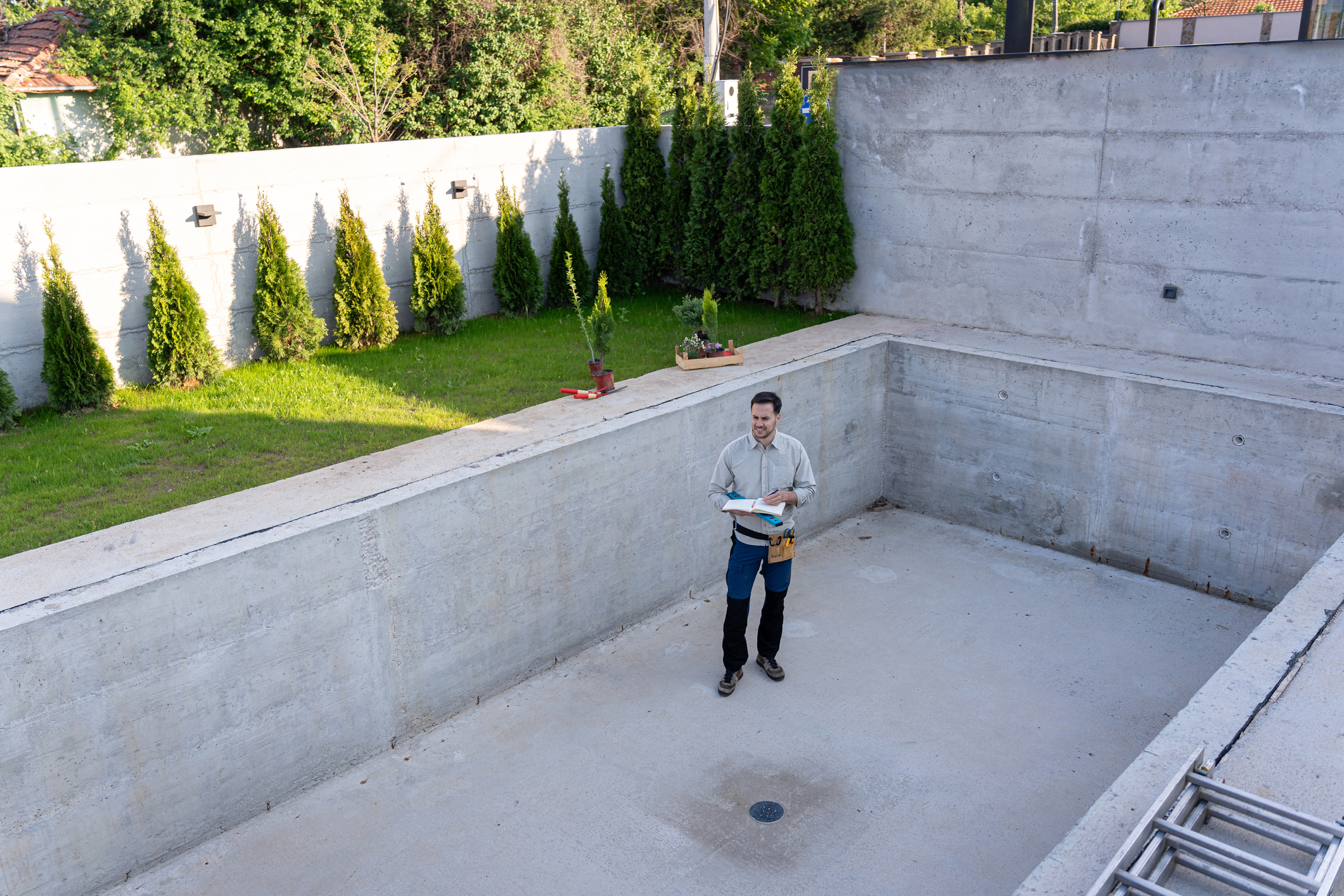 Positive pool 15 Master engineer inspecting the construction of a luxurious yard and swimming pool